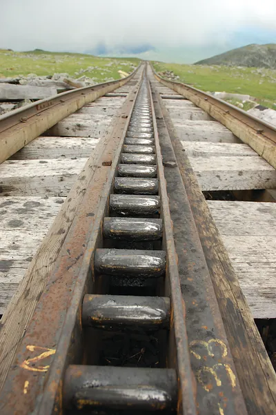 Cog railway track with central rack rail on mountain