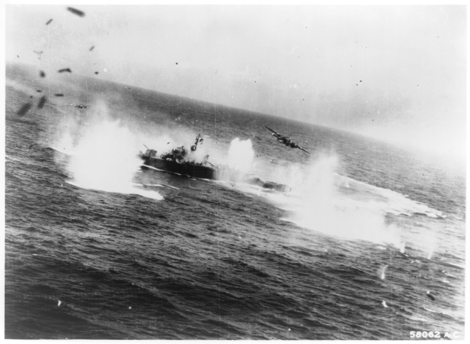 Two North American B-25's churn the water with hits and near misses on a Japanese frigate in the March 29, 1945 attack which cost the Japs nine ships, South China Sea, 1945 — historic photograph