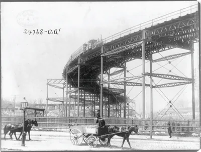 [New York City - elevated train on curve above horse-drawn wagon]