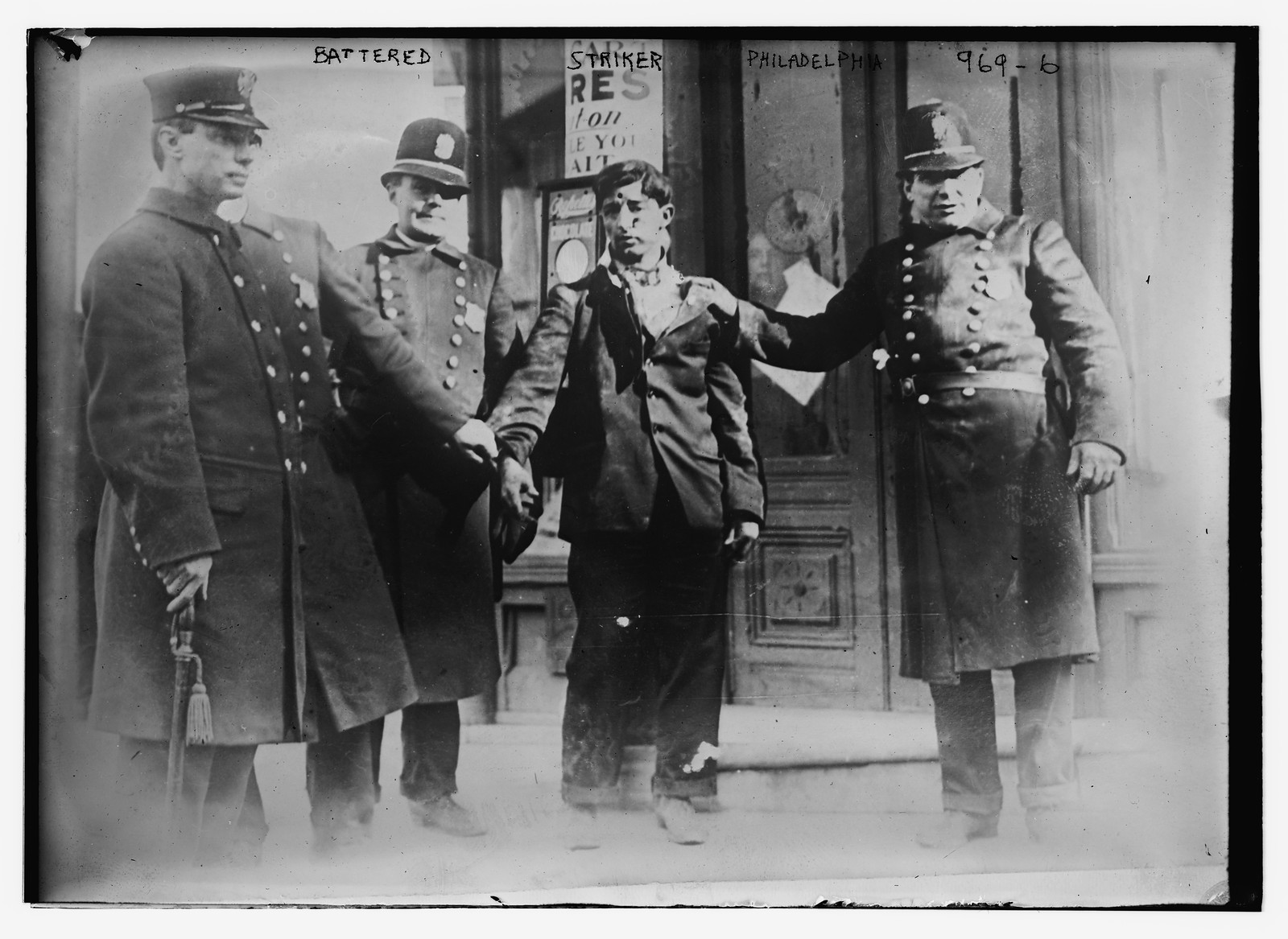 Battered striker with policemen, Philadelphia, 2/24/10. — historic photograph