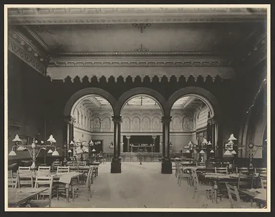 Interior of a reading room with arches and tables