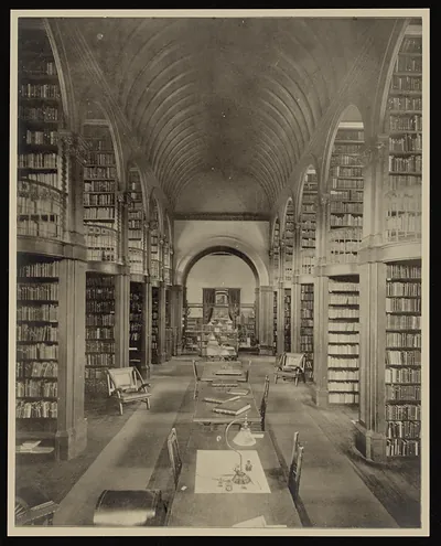Library interior with vaulted ceiling, bookshelves and reading tables