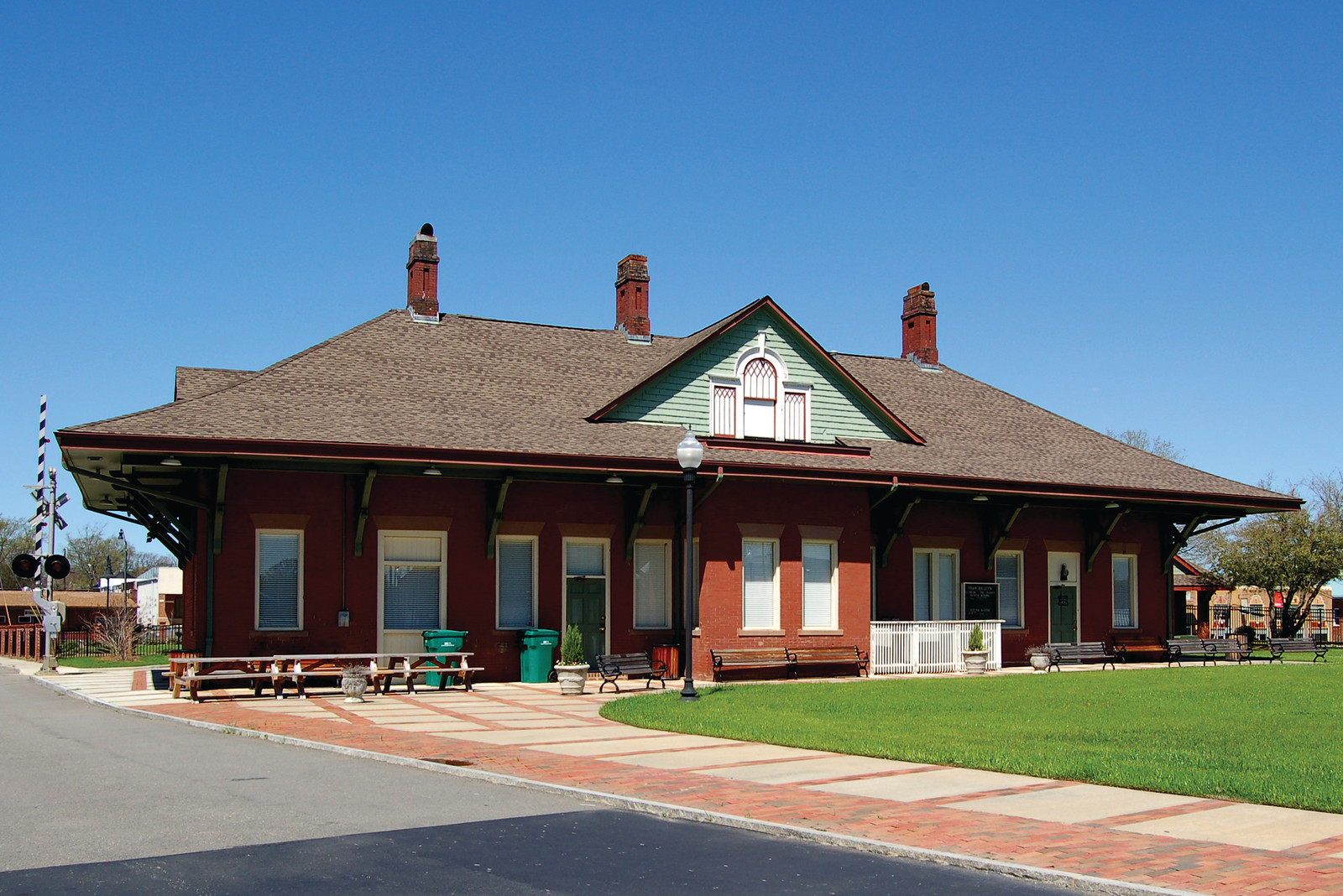 Red brick railroad depot with green gabled dormer — historic image