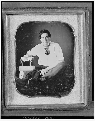 Daguerreotype occupational portrait of seated young person with flatiron