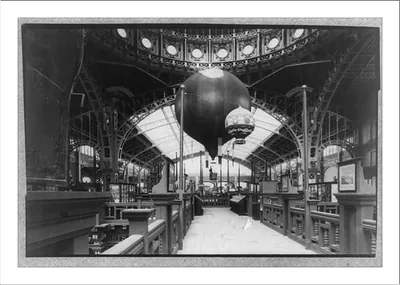 [Interior of Paris Exposition building showing two balloons]