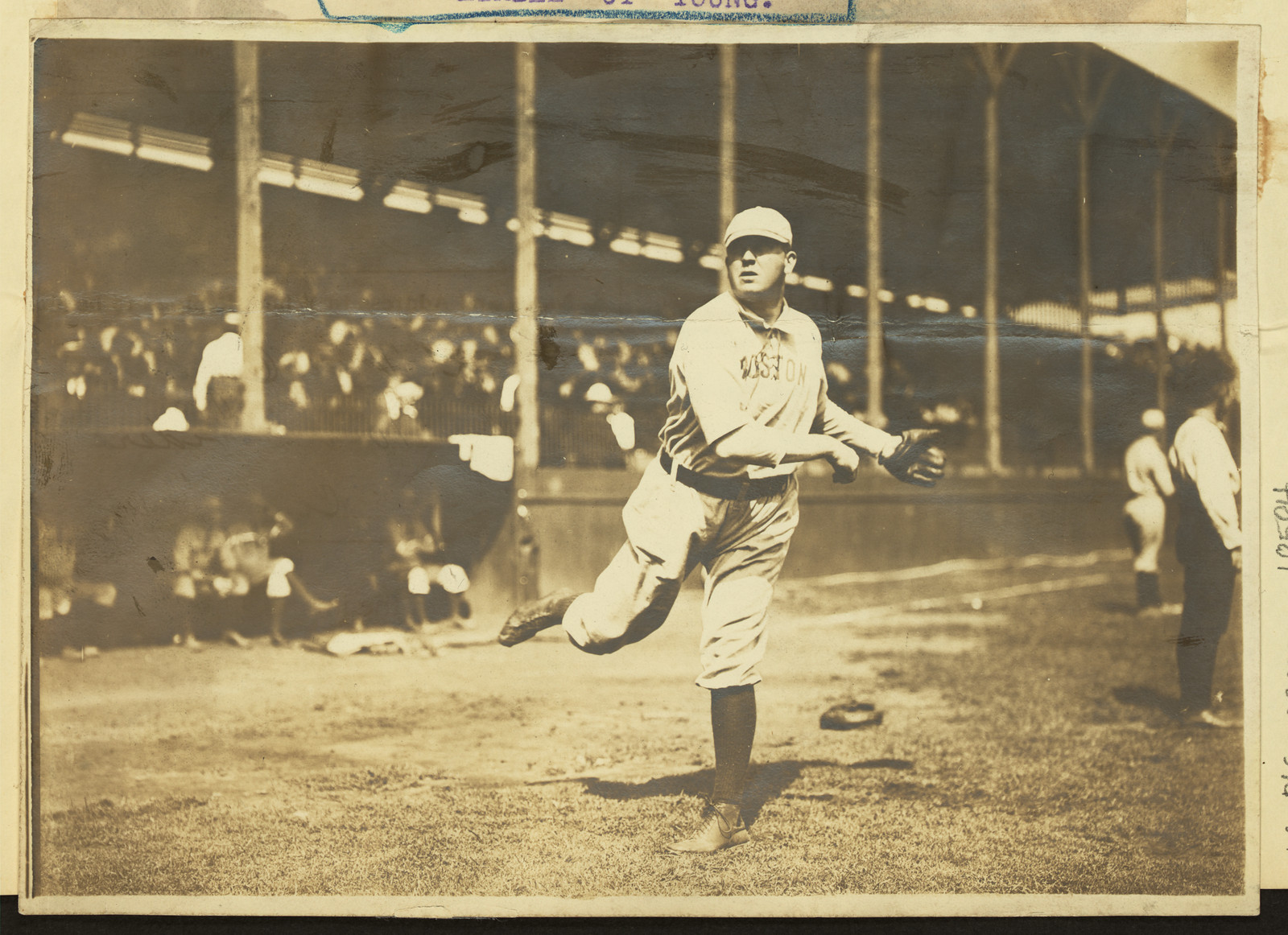 Baseball pitcher in Boston uniform on a ballpark field — historic image