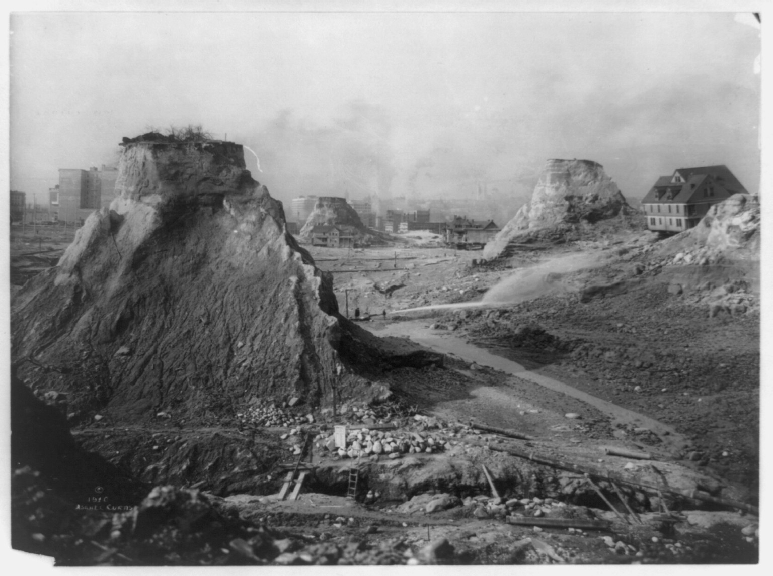 The leveling of the hills to make Seattle [Denny Hill] / Asahel Curtis., 1910, c1911. — historic photograph