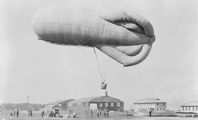 Military observation balloon with ground crew and hangars