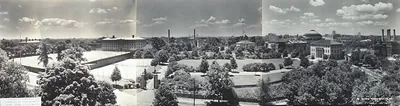 Panoramic view of a university campus with lawns and domed building