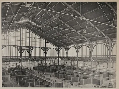 Iron-framed covered market hall with rows of pens