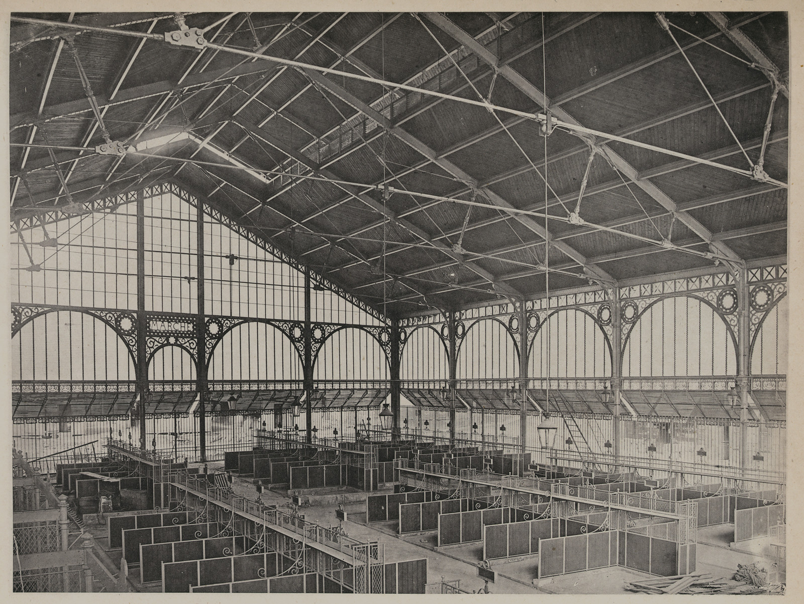 Iron-framed covered market hall with rows of pens — historic image