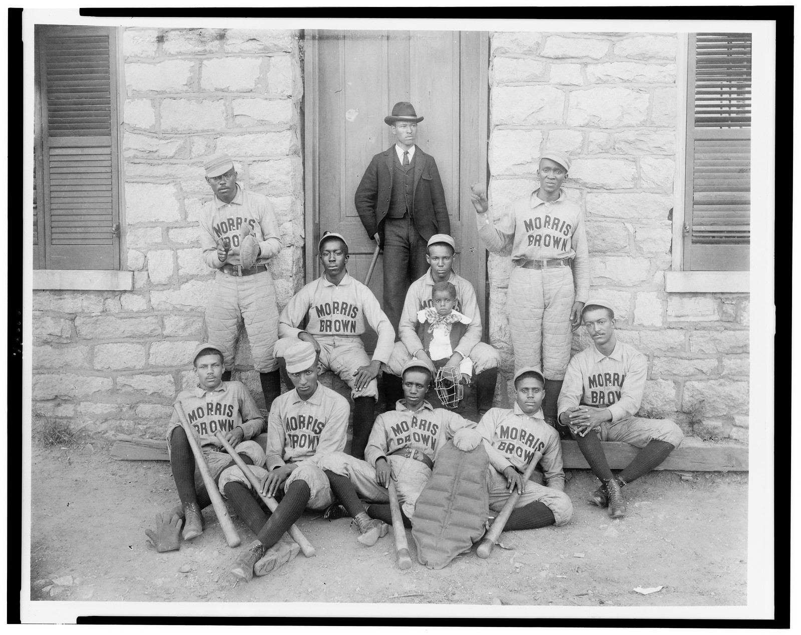 [African American baseball players from Morris Brown College, with boy and another man standing at door, Atlanta, Georgia], [1899 or 1900] — historic photograph