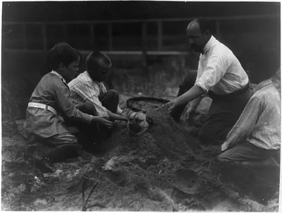 Theo Roosevelt's children burying a dog in the sand