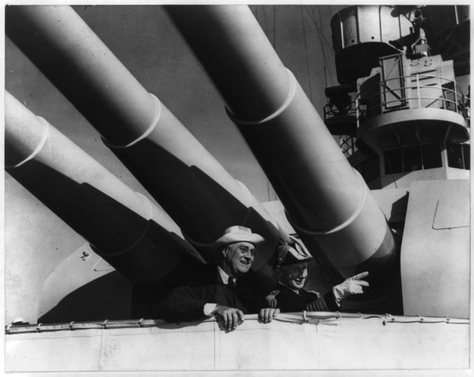 President Franklin D. Roosevelt and Admiral Claude C. Bloch under the big guns of the U.S.S. HOUSTON at San Francisco, California, [no date recorded on caption card] — historic photograph