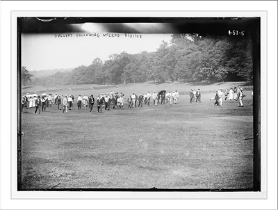 Golf match, crowd following Fred McLeod