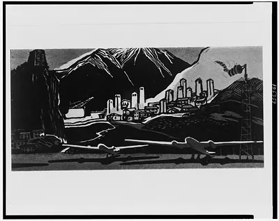 [Airplanes on field in foreground, buildings, and mountains in background]