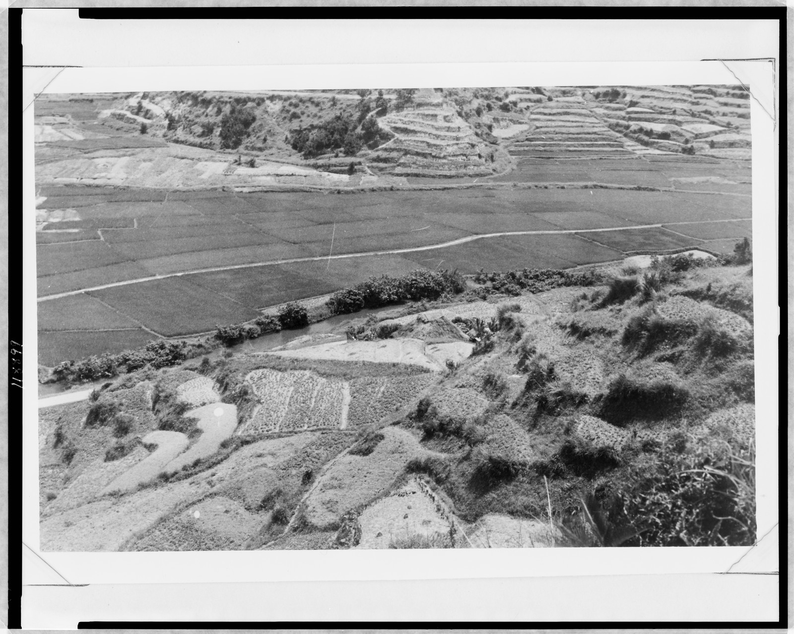 To prevent the soil from land slide the keen (sic) slopes are made into innumerable terrace, of which some are just a size for a farmer to work, [between 1949 and 1960] — historic photograph