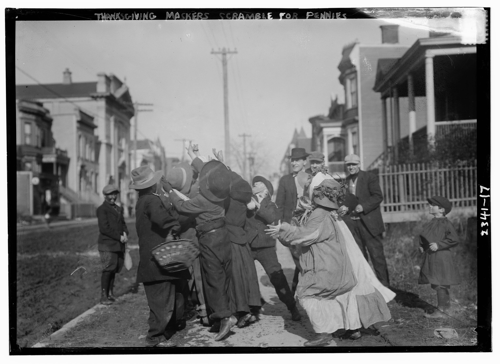 Thanksgiving Maskers scramble for pennies, n/a — historic photograph