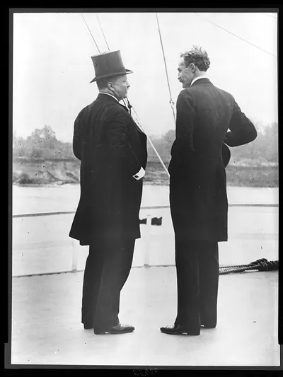 [President Theodore Roosevelt and Gifford Pinchot, full-length portrait from behind, standing on deck of steamer Mississippi, during tour of Inland Waterways Commission]