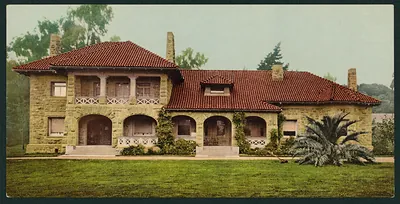 Stone lodge with red tile roof and arched porches