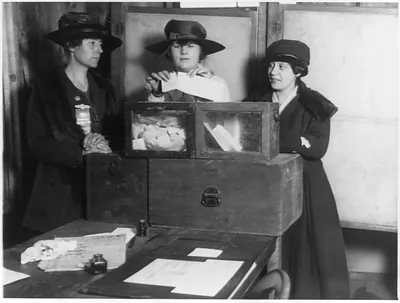 [Three suffragists casting votes in New York City(?)]