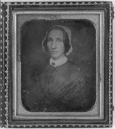 [Unidentified woman, head-and-shoulders portrait, facing slightly to left, seated in chair]