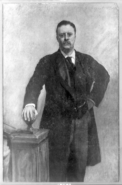 [Theodore Roosevelt, three-quarter length portrait, standing, facing front, right hand on stairway post]