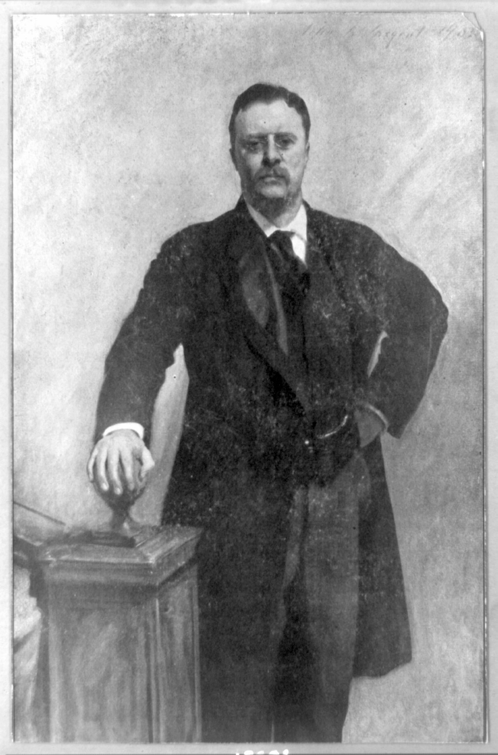 [Theodore Roosevelt, three-quarter length portrait, standing, facing front, right hand on stairway post], [1903] — historic print