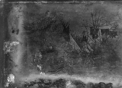 [View of a Cheyenne village at Big Timbers, in present-day Colorado, with four large tipis standing at the edge of a wooded area. Frame with pemmican or hides hanging at the right; two figures, facing camera, standing to the left of center]