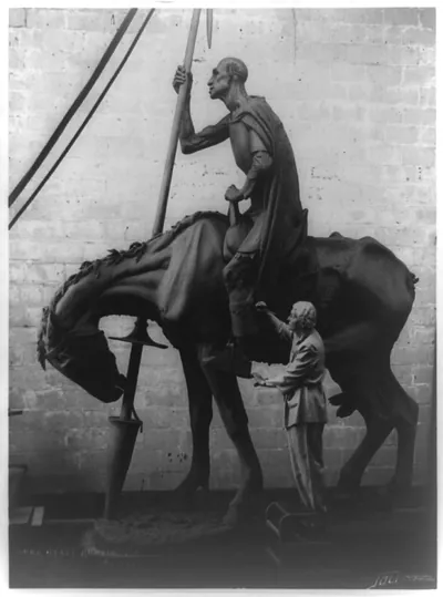 [Anna Hyatt Huntington, sculptor, putting final touches on her equestrain statue of Don Quixote] / Joli photographers.