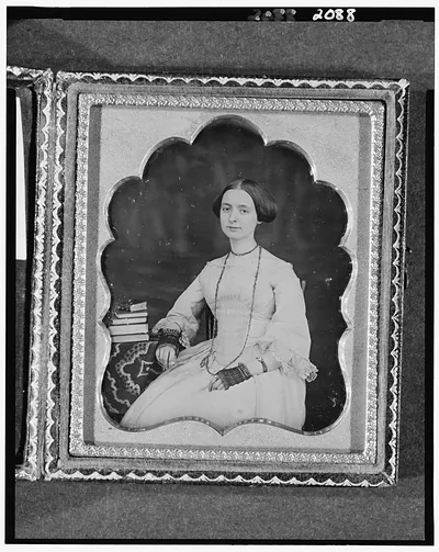 [Mary Ann Bartlett, three-quarter length portrait of a woman, seated, beside table with books and tablecloth]