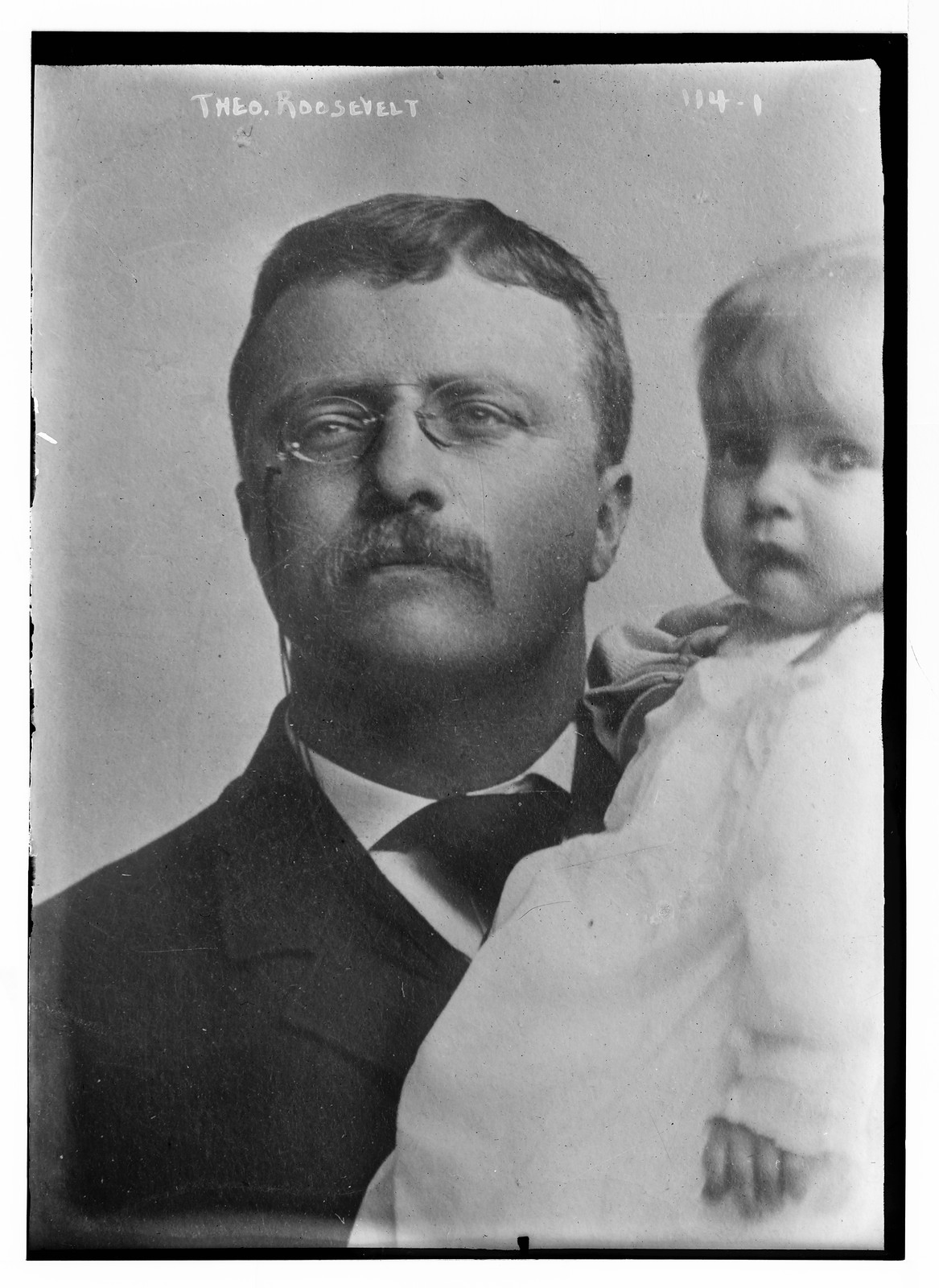 Theodore Roosevelt, holding child, n/a — historic photograph