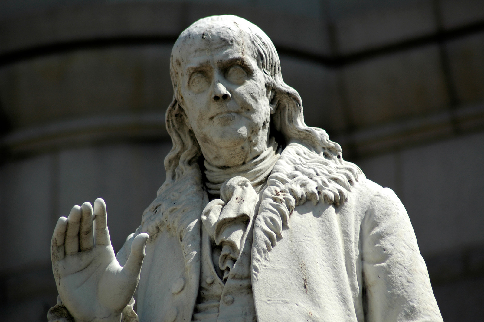 Marble statue of Benjamin Franklin with raised hand — historic image
