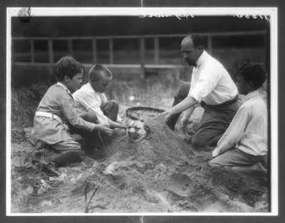 Theo Roosevelt's children burying a dog in the sand