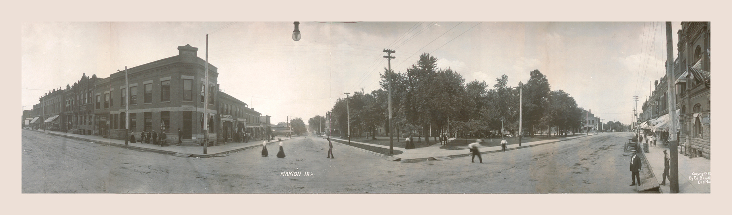 Panoramic street scene with 'MARION IA' printed on the roadway, 1907 — historic print