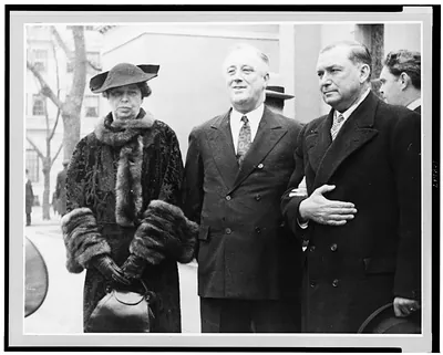[Franklin D. Roosevelt, three-quarter length portrait, standing between Eleanor Roosevelt and an unidentified man, facing slightly left]