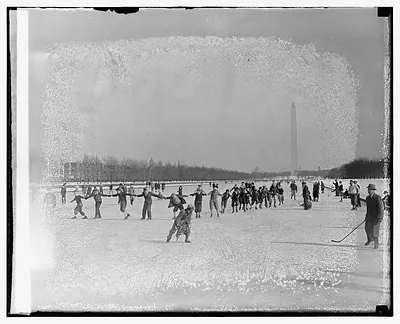 [People ice skating, Washington Monument in background]