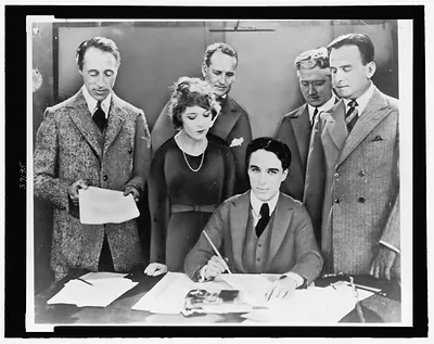 [D.W. Griffith, Mary Pickford, Charlie Chaplin (seated) and Douglas Fairbanks at the signing of the contract establishing United Artists motion picture studio]