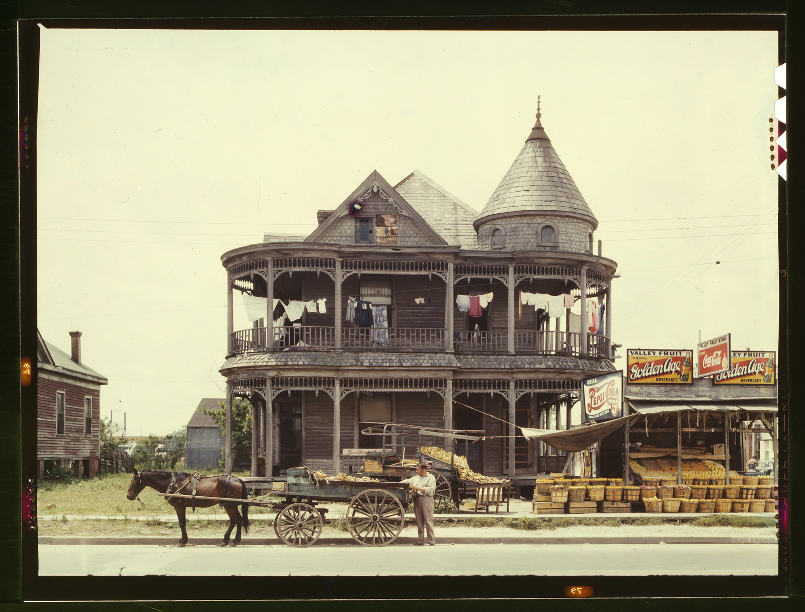 Victorian house with fruit stand and horse-drawn cart — historic image
