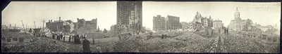 Panoramic view of a city street ruined by fire, with domed building