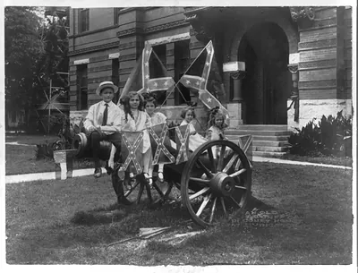 [Five children seated on an old Confederate cannon in Court House Square, Livingston, Alabama]