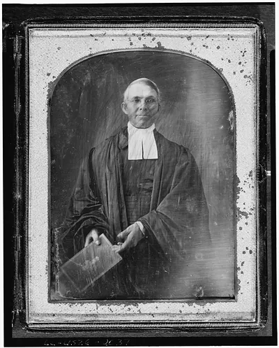 Daguerreotype portrait of a clergyman in robes holding a book