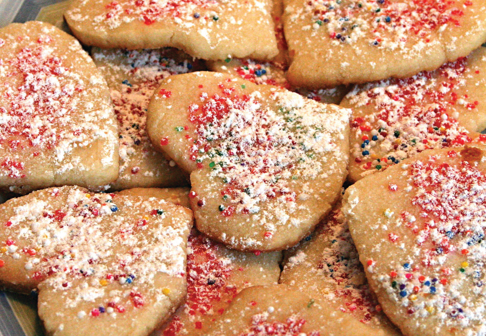 Heart-shaped sugar cookies with red and white sprinkles — historic image