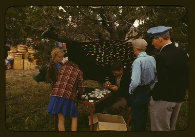 Vendor selling initial pins at an outdoor fair stall
