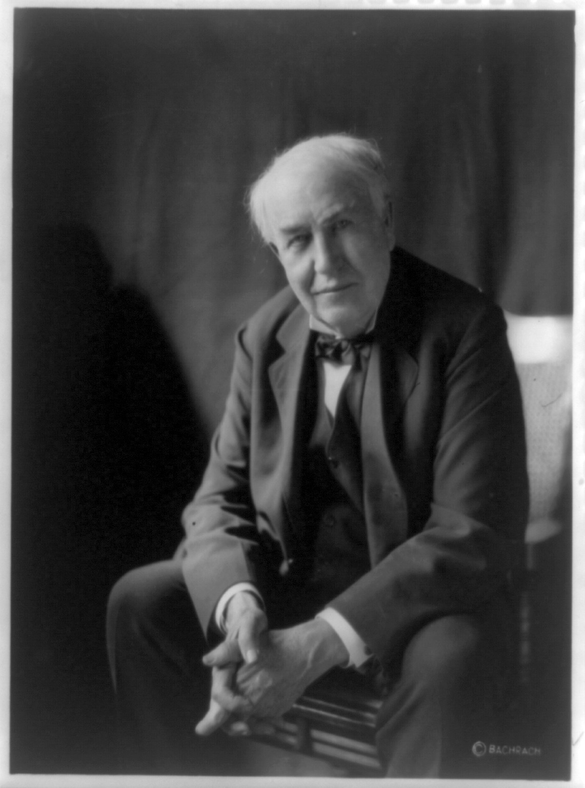 [Thomas Alva Edison, three-quarter length portrait, seated, facing left, hands folded], 1922 — historic photograph
