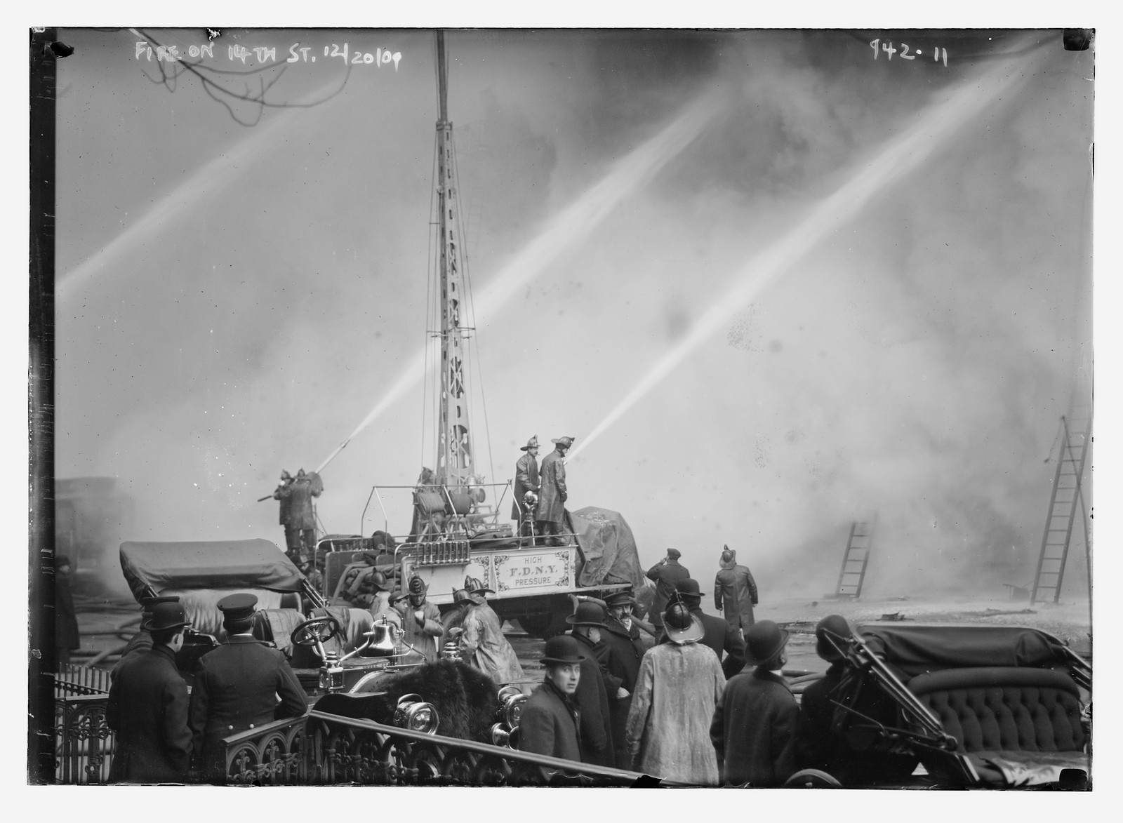 Firemen and equipment used against burning building on 14th St., New York, 12/20/09. — historic photograph
