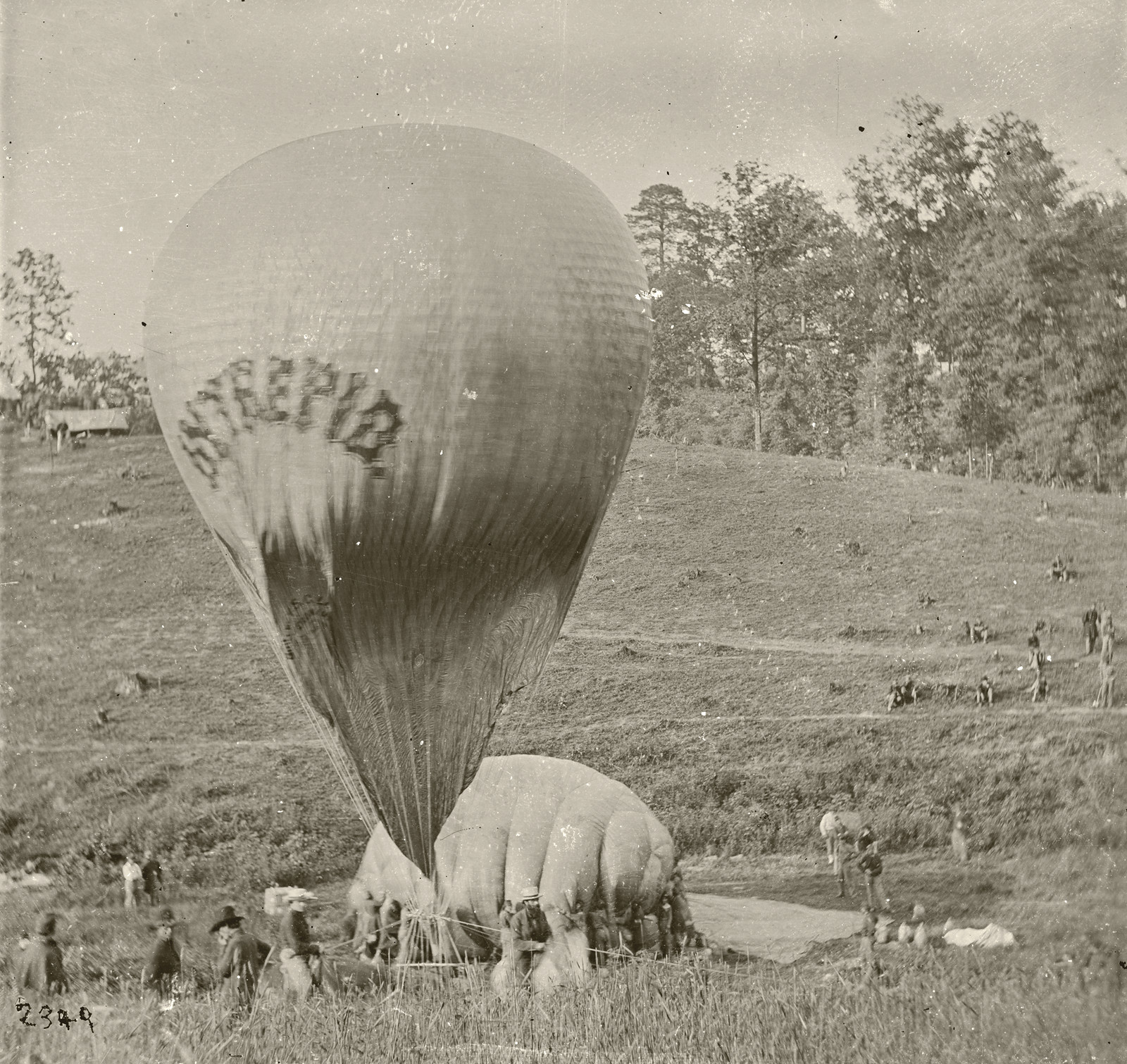 Civil War observation balloon being inflated in a grassy field — historic image