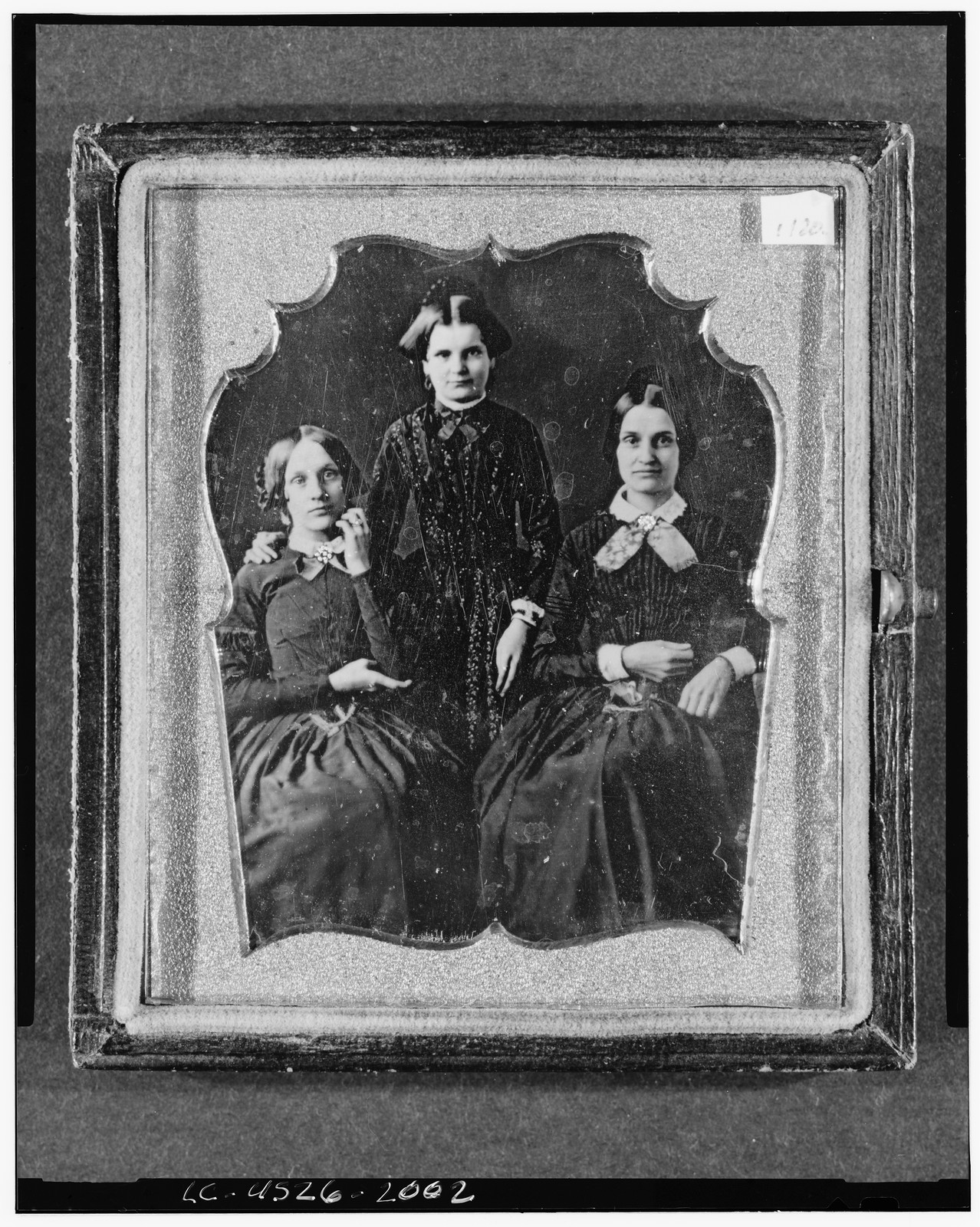 [Three unidentified women, two seated, one standing, facing front], [between 1840 and 1860] — historic photograph