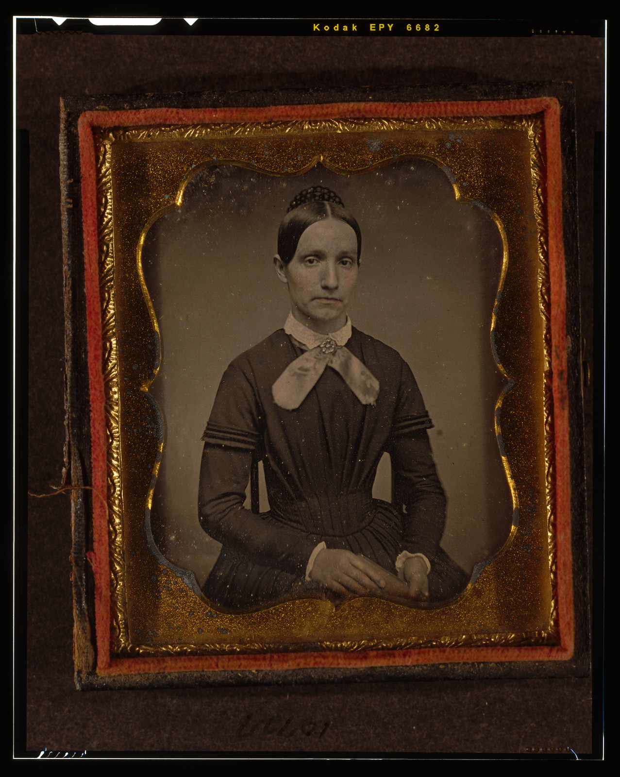 Seated woman in ornate daguerreotype case, 1840 — historic photograph