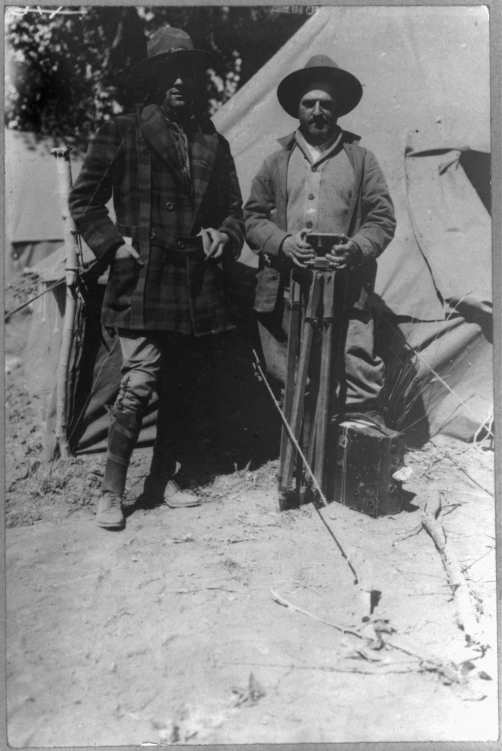 [Tracy Mathewson and William Fox, news photographers, in camp with movie camera], c1916 May 24. — historic photograph